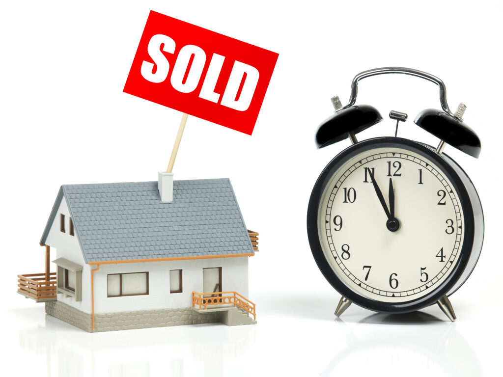 Sold house model and clock representing fast cash sale timeline